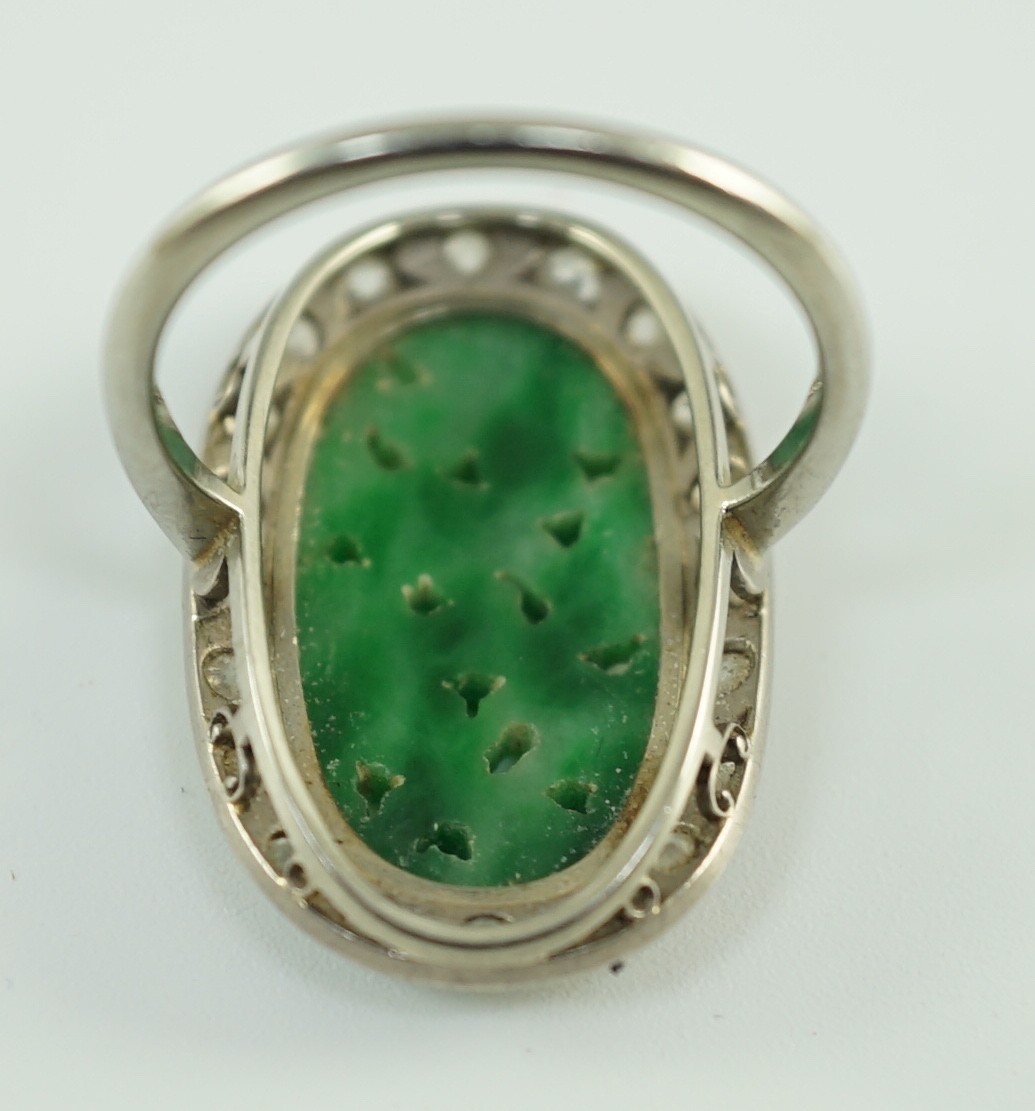 A 1920's/1930's white gold, jadeite and diamond set oval dress ring